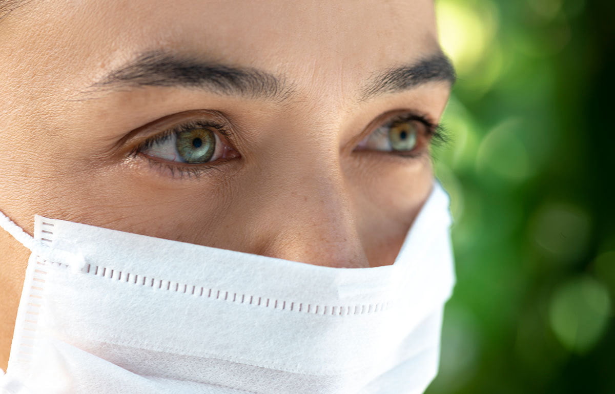 Woman gets facial procedures at Cosmetic Surgerons of Michigan to show off her eyes over her mask