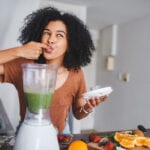 Woman Enjoys Healthy Snacks and Smoothie Between Meals