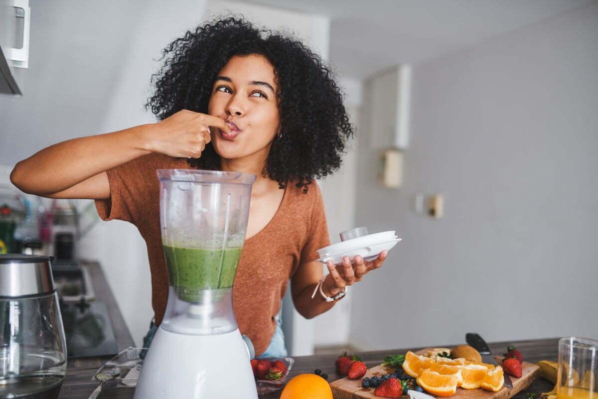 Woman Enjoys Healthy Snacks and Smoothie Between Meals