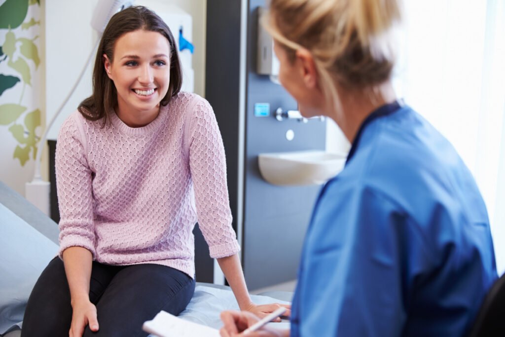 Woman talking to a patient care coordinator before a cosmetic surgery consultation